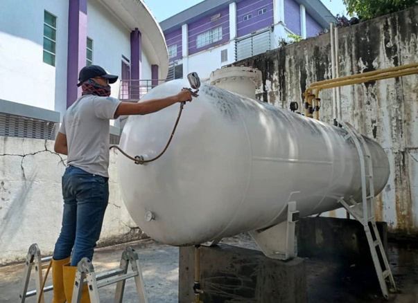 Technician inspecting an LPG bulk tank